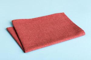 top view red empty kitchen napkin isolated on table background. Folded cloth for mockup with copy space photo