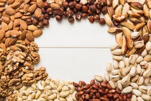 different nuts frame background. with vopy space. Walnut, pistachios, almonds, hazelnuts and cashews photo