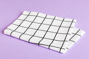 top view white empty kitchen napkin isolated on table background. Folded cloth for mockup with copy space photo