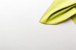 top view with green kitchen napkin isolated on table background. Folded cloth mockup with copy space photo