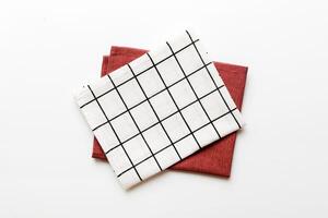 top view with white empty kitchen napkin isolated on table background. Folded cloth mockup with copy space photo