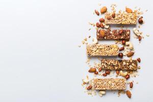 Various granola bars table background. Cereal granola bars. Superfood breakfast bars with oats, nuts and berries, photo