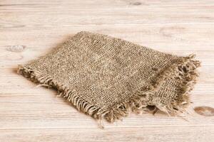 Old burlap fabric napkin, sackcloth table background. top view with copy space photo