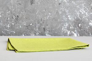 top view green kitchen napkin isolated on table background. Folded cloth for mockup with copy space, Minimal style photo
