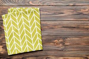 top view with green kitchen napkin isolated on table background. Folded cloth for mockup with copy space photo