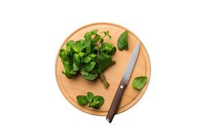 Fresh mint on Cutting board table isolated white background, top view. Flat lay Space for text photo