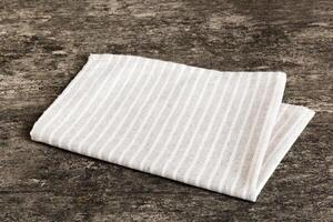 top view with gray kitchen napkin isolated on table background. Folded cloth for mockup with copy space. Minimal style photo