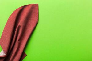 top view red empty kitchen napkin isolated on table background. Folded cloth for mockup with copy space, Minimal style photo