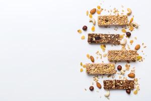Various granola bars on table background. Cereal granola bars. Superfood breakfast bars with oats, nuts and berries. Superfood concept photo