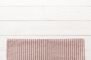 top view red empty kitchen napkin isolated on table background. Folded cloth for mockup with copy space, photo