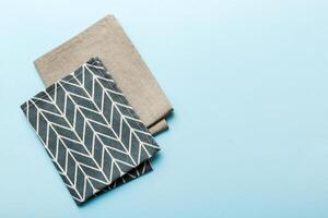top view with blue kitchen napkin isolated table background. Folded cloth for mockup with copy space, Minimal style photo