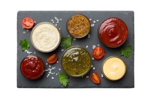 Many different sauces and herbs isolated white background, flat lay top view. sauces on plate, healthy concept photo