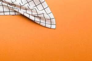 top view with white empty kitchen napkin isolated on table background. Folded cloth for mockup with copy space, Minimal style photo