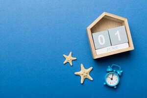 Image of june 1 wooden calendar colored background. Summer day. Empty space for text photo