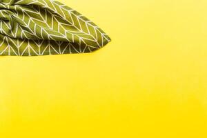 top view with green kitchen napkin isolated on table background. Folded cloth for mockup with copy space, Minimal style photo
