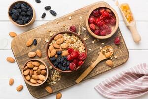 Cooking wholesome breakfast. Granola Various dried fruits and nuts in a bowl. The concept of a healthy dessert. Flat lay, top view with copy space photo