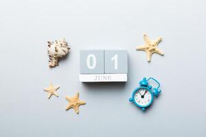 Image june 1 wooden calendar on colored background. Summer day. Empty space for text photo
