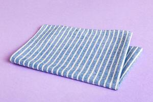 top view with blue kitchen napkin isolated on table background. Folded cloth for mockup with copy space, Minimal style photo