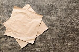 top view with baking parchment empty on table background. Folded cloth for mockup with copy space. Minimal style photo