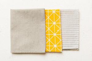 top view with gray kitchen napkin isolated on table background. Folded cloth mockup with copy space, Flat lay. Minimal style photo