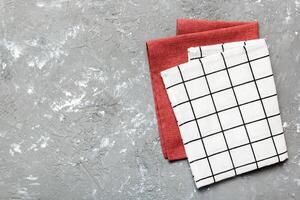 top view with white empty kitchen napkin isolated on table background. Folded cloth for mockup with copy space, photo