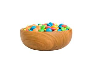 Multicolored candies in bowl on a colored background. birthday and holiday concept. Top view with copy space photo