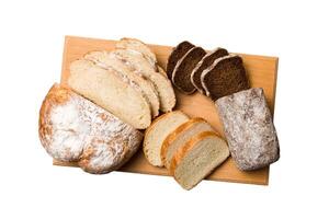 Freshly baked bread slices cutting board isolated on white background . Sliced bread photo