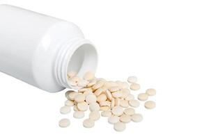 White medicines flow from container. medicine white pill bottle isolated on white background photo