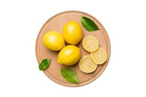 Top view copy space for fresh and ripe lemons on cutting board. Healthy food background. Elegant background of lemon and lemon slices isolated on white background photo