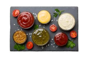 Many different sauces and herbs isolated white background, flat lay top view. sauces on plate, photo