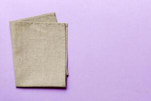 top view with gray kitchen napkin isolated on table background. Folded cloth mockup with copy space, Minimal style photo