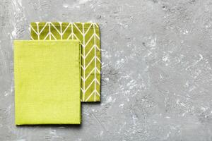top view with green kitchen napkin isolated table background. Folded cloth for mockup with copy space. Minimal style photo
