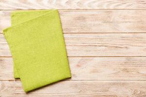 top view green kitchen napkin isolated on table background. Folded cloth for mockup with copy space, Flat lay. Minimal style photo