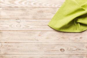 top view with green kitchen napkin isolated on table background. Folded cloth for mockup with copy space. Minimal style photo