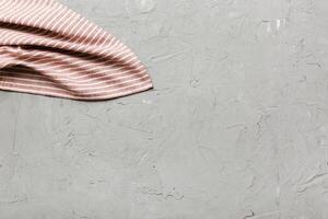 top view red empty kitchen napkin isolated on table background. Folded cloth mockup with copy space, Minimal style photo