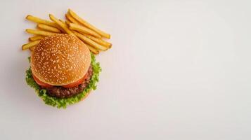 Delicious Burger and Fries on a White Background Perfect for Lunch Breaks and Fast Food Promotions photo