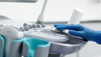 The hands of an ultrasound diagnostician on the control panel of an ultrasound machine during the examination. The concept of modern technology and advanced methods in medical imaging video