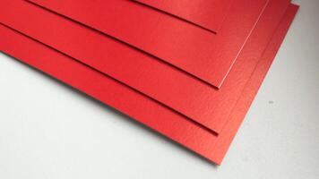 A stack of red paper sheets on a white surface video