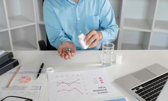 Office Worker Feeling Unwell with Cold Symptoms at Desk with Medication and Business Documents in Modern Workspace photo