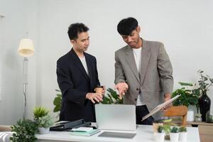 Business Collaboration and Teamwork. Two professionals discussing ideas in a modern office setting. photo