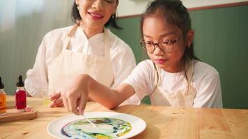 Mother and Daughter Watching Milk Color Reaction Science Experiment video