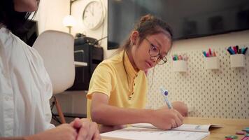 Child focusing on writing activity in creative home classroom video