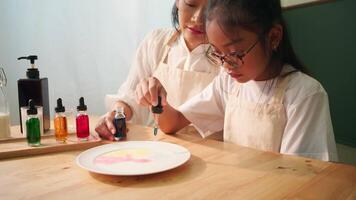 Child Adding Food Coloring into Milk Plate with Parent Homeschool Science Activity video