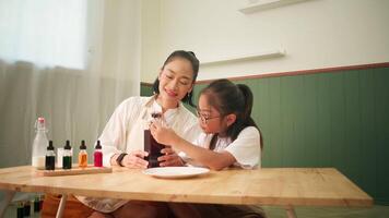 Mother and child laughing together during DIY science activity video