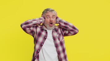 Mature man covering ears, intense fear gesture, startled panic from loud noise shocking reaction video