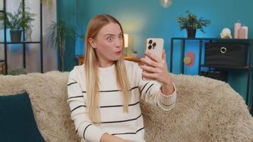 Caucasian woman smiling laughing talking during phone call on sofa at home joyful emotions video