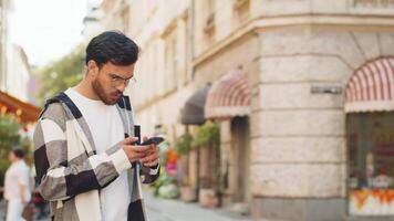 Tourist man using smartphone looking for search way on map in mobile navigator app on city street video