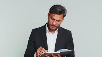 Business man making notes writing down thoughts with pen into notepad notebook diary, good idea video