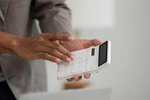 Calculator Use and Business Analysis. A professional using a calculator during a business meeting. photo