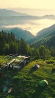 Camping high in the mountains from a bird's eye view. Incredible landscape on top of the mountain at sunrise. Morning fog in the mountains. Dawn in the video
